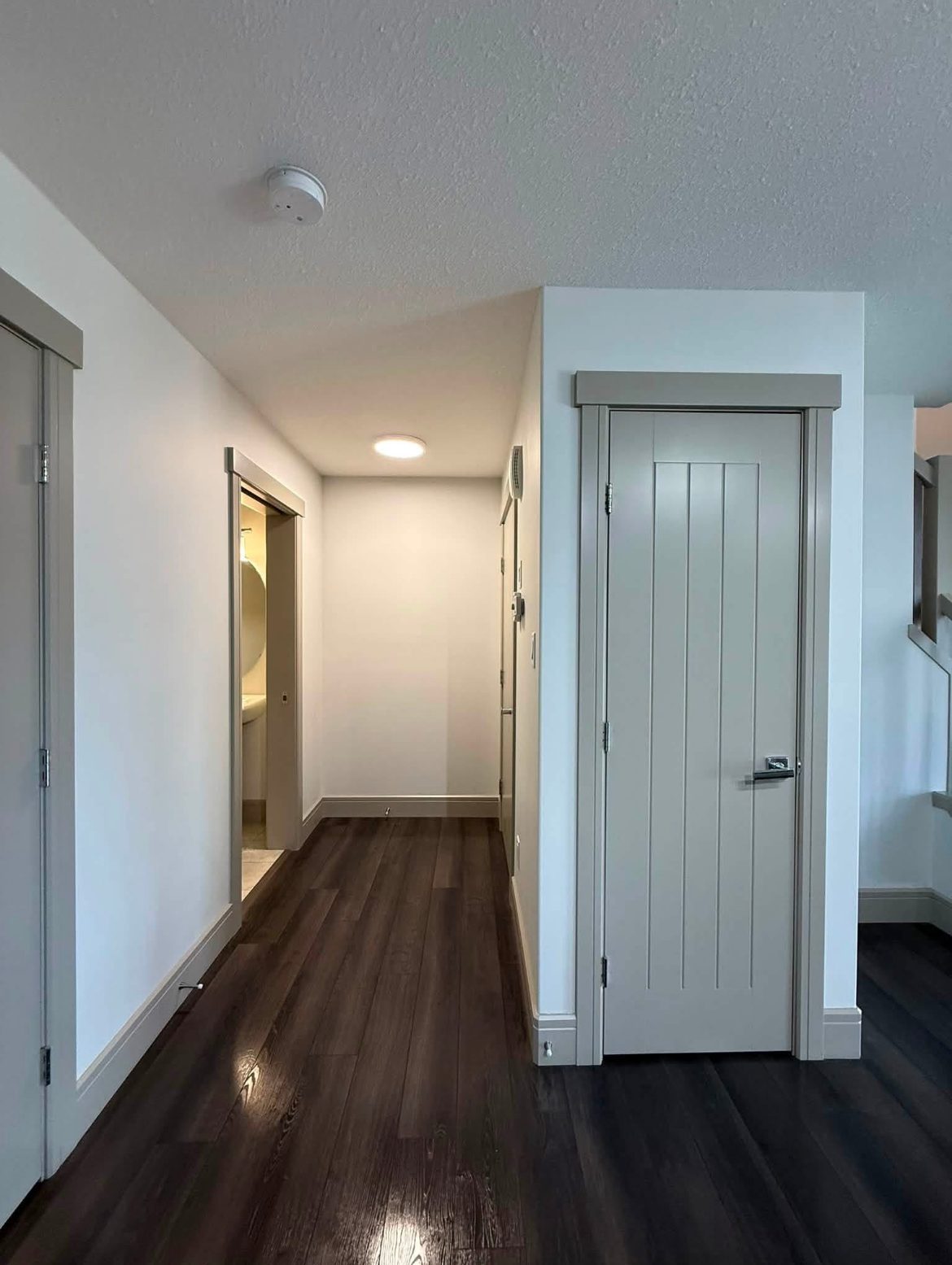 A clean hallway with hardwood flooring